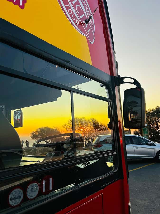 Cape Town: Sunset Bus Tour with Picnic on Signal Hill - Cape Town after dark on the return route