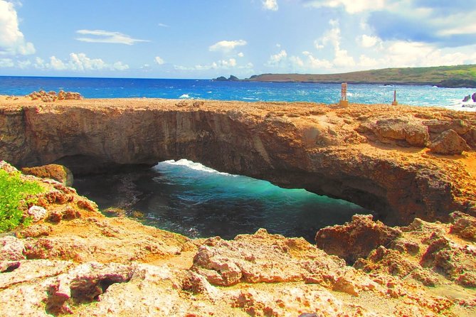 Colorful Beach Bus Sightseeing Tour of Aruba - The cave pool and cliff-jumping stop