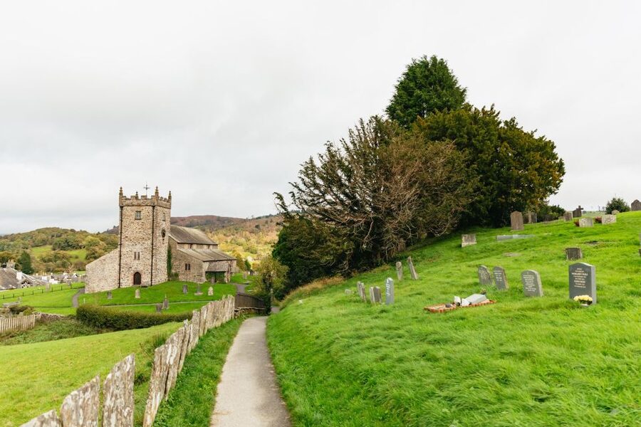 From Manchester: Lake District Bus Tour & Windermere Cruise - Coniston Water and the road through the hills