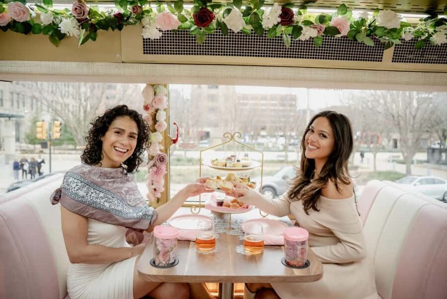 Houston: Tea Around Town® Afternoon Tea Bus Tour - A pink bus with a very Houston point of view