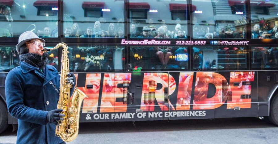 New York City: The Ride Interactive Bus Tour - Street performers turn landmarks into scenes